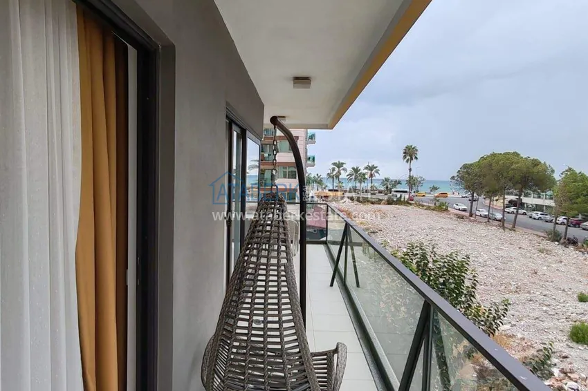 Purchase  1+1 apartment with sea view in the Oba area - first line, furnished, suitable for a residence permit 15 