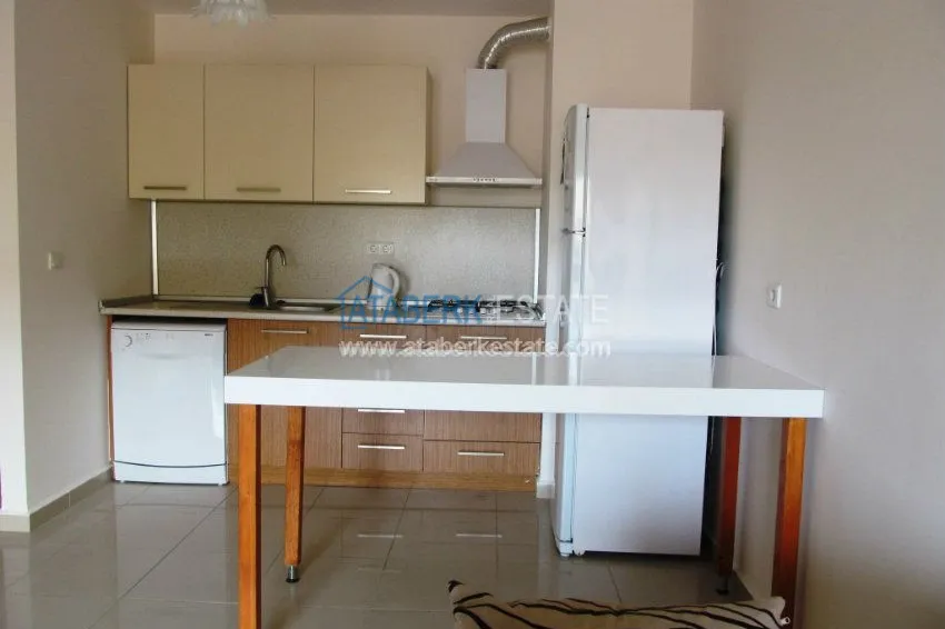 Меблированная двухкомнатная квартира в центре современного района Махмутлар.  12 